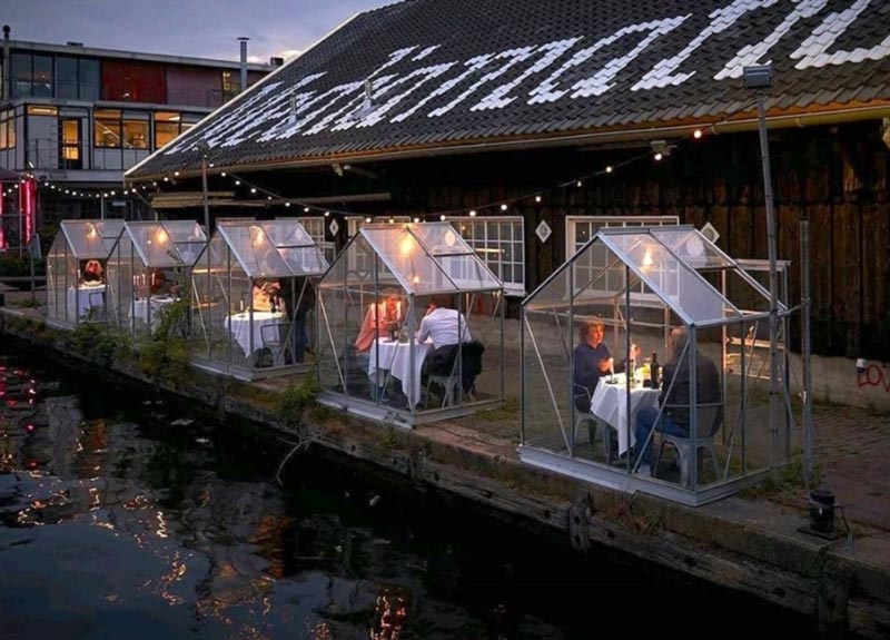 Image of an innovative outside dining alternative from Amsterdam using so called greenhouse quarantine styles